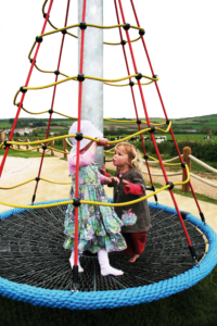 Kids Playin On Spiral Carousel