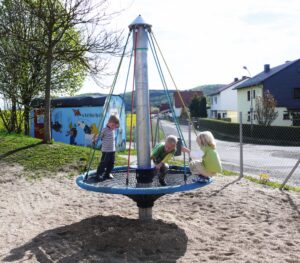 Kids Playing On Birds Nest Carousel