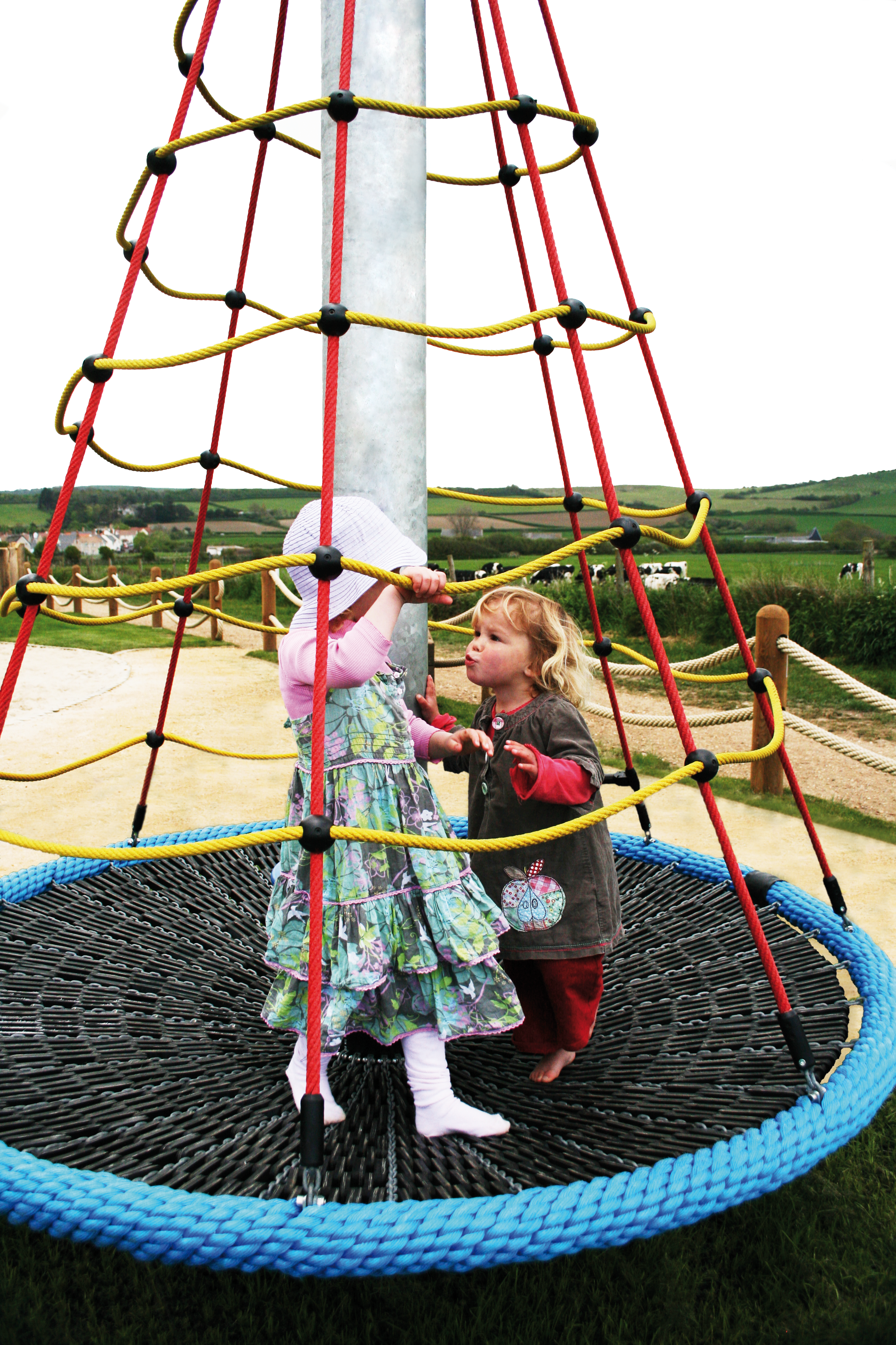 Children Playing On Spiral Carousel